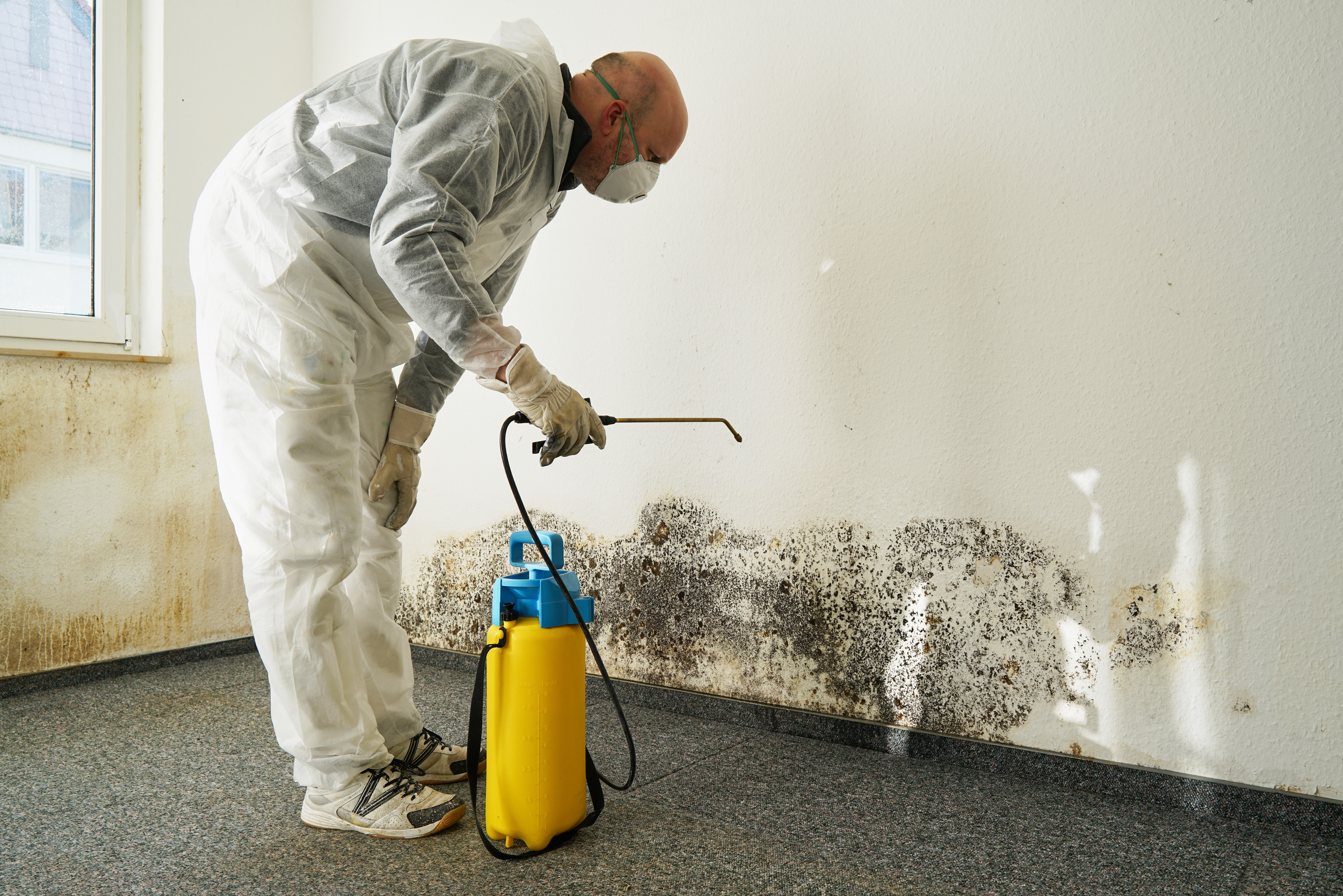 Suncoast technician in full PPE performing sewage cleanup under IICRC S500 protocol